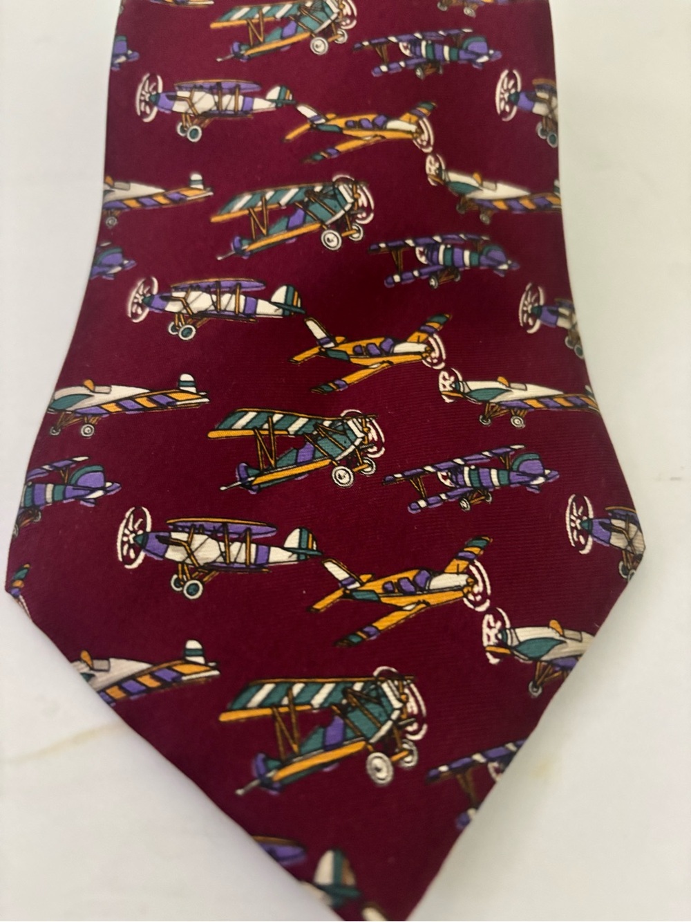 Sir George University Shop burgundy silk tie with vintage biplanes.